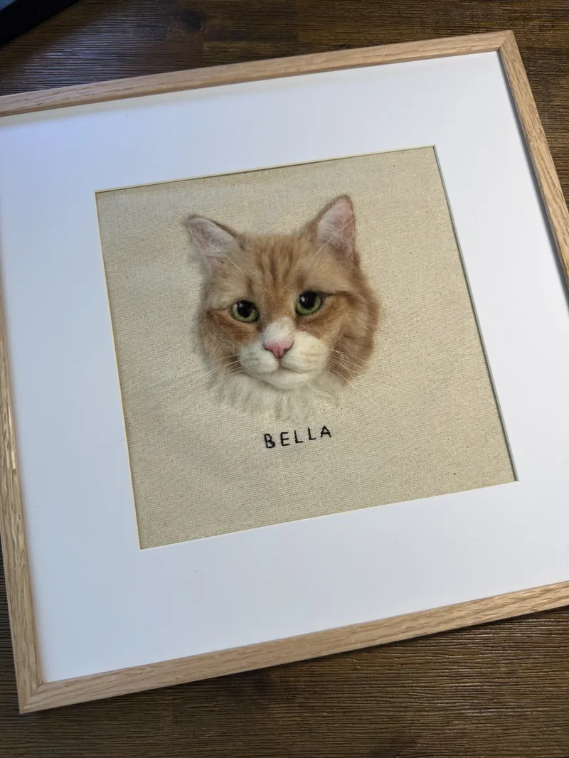 White dog portrait with brown accents in a wooden frame with comparison photos